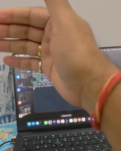 Filmed on a phone while the app ran: a wave switches apps, a wave up spreads every window out, pointing moves the highlight, a pinch opens a window, a double pinch opens a folder and then a photo, a pinch opens Finder, and thumb to ring finger scrolls the list